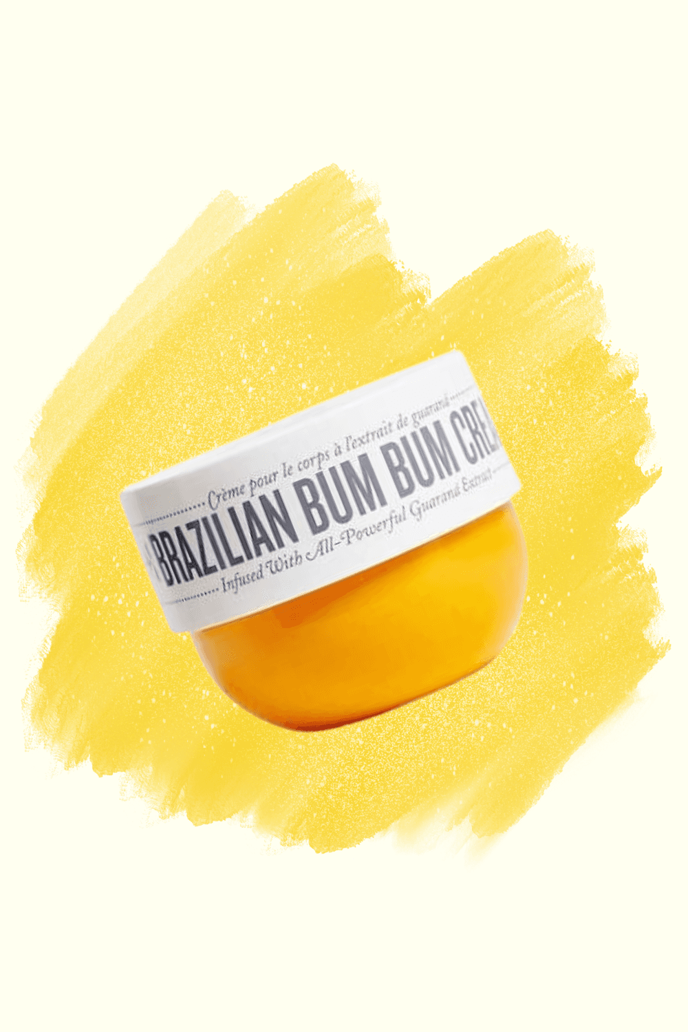A Sol de Janeiro Brazilian Bum Bum Cream jar on a yellow brushstroke background